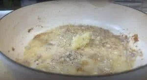 Sautéing garlic and onion in a pan, perfect start for a flavorful dish.